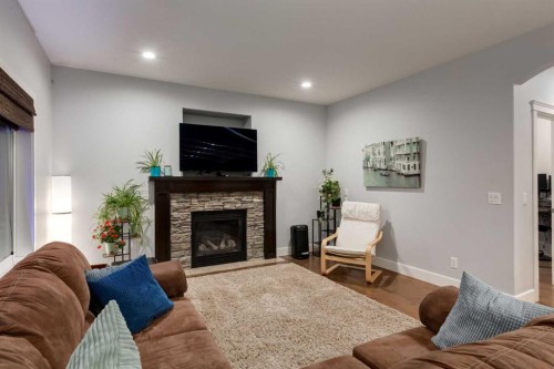 2050 High Country Rise, High River, AB - Indoor Photo Showing Living Room With Fireplace