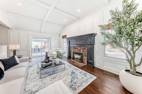 36 Stradbrooke Way Sw, Calgary, AB - Indoor Photo Showing Living Room With Fireplace