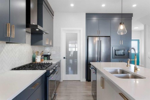 96 Emberside Glen, Cochrane, AB - Indoor Photo Showing Kitchen With Stainless Steel Kitchen With Double Sink With Upgraded Kitchen