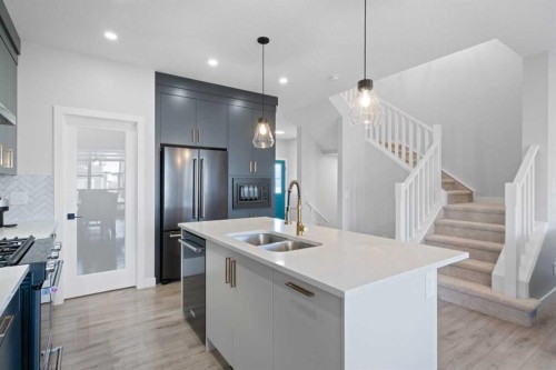 96 Emberside Glen, Cochrane, AB - Indoor Photo Showing Kitchen With Stainless Steel Kitchen With Double Sink With Upgraded Kitchen