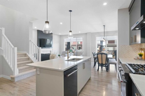 96 Emberside Glen, Cochrane, AB - Indoor Photo Showing Kitchen With Double Sink With Upgraded Kitchen
