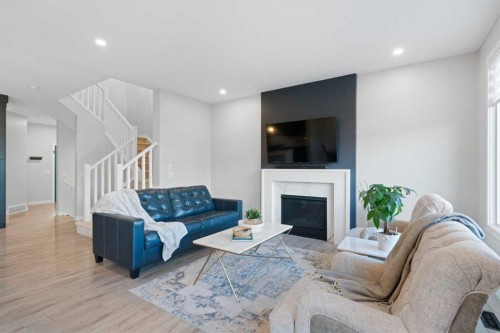 96 Emberside Glen, Cochrane, AB - Indoor Photo Showing Living Room With Fireplace