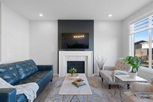 96 Emberside Glen, Cochrane, AB - Indoor Photo Showing Living Room With Fireplace