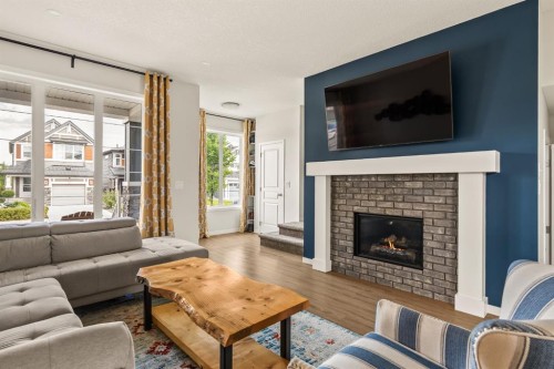 63 Seton Gardens Se, Calgary, AB - Indoor Photo Showing Living Room With Fireplace