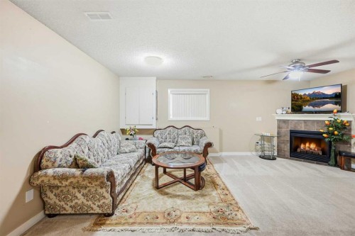 81 Saddlemont Road Ne, Calgary, AB - Indoor Photo Showing Living Room With Fireplace