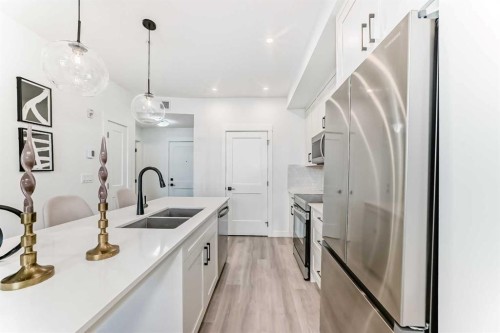 105-30 Sage Hill Walk Nw, Calgary, AB - Indoor Photo Showing Kitchen With Stainless Steel Kitchen With Double Sink With Upgraded Kitchen