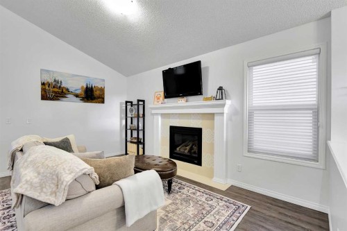 65 Sunset Heights, Cochrane, AB - Indoor Photo Showing Living Room With Fireplace