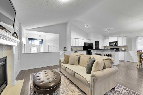 65 Sunset Heights, Cochrane, AB - Indoor Photo Showing Living Room With Fireplace