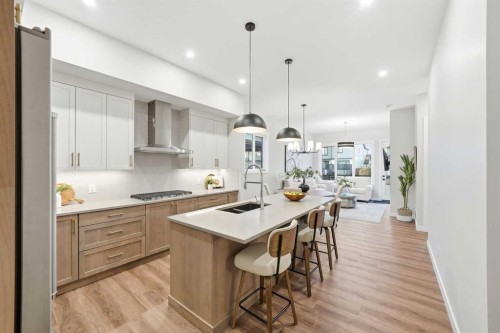 108 Quartz Crescent, Cochrane, AB - Indoor Photo Showing Kitchen With Double Sink With Upgraded Kitchen