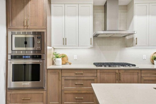 108 Quartz Crescent, Cochrane, AB - Indoor Photo Showing Kitchen With Upgraded Kitchen