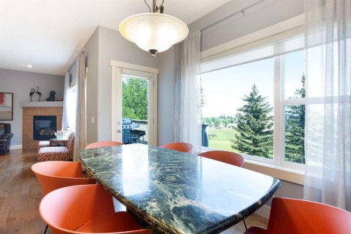 62 Panamount Road Nw, Calgary, AB - Indoor Photo Showing Dining Room With Fireplace