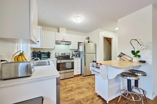 2366 Eversyde Avenue Sw, Calgary, AB - Indoor Photo Showing Kitchen With Double Sink