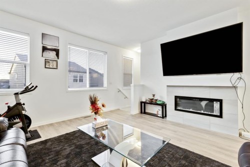 620 Copperstone Manor Se, Calgary, AB - Indoor Photo Showing Living Room With Fireplace