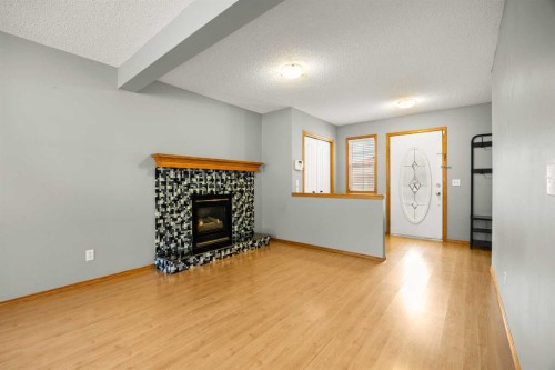 36 Arbour Wood Crescent Nw, Calgary, AB - Indoor Photo Showing Living Room With Fireplace