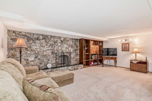 111 Oakside Road Sw, Calgary, AB - Indoor With Fireplace