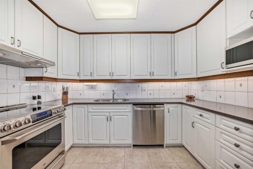 111 Oakside Road Sw, Calgary, AB - Indoor Photo Showing Kitchen With Double Sink