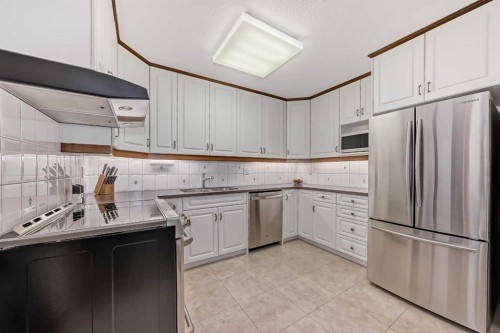 111 Oakside Road Sw, Calgary, AB - Indoor Photo Showing Kitchen With Double Sink