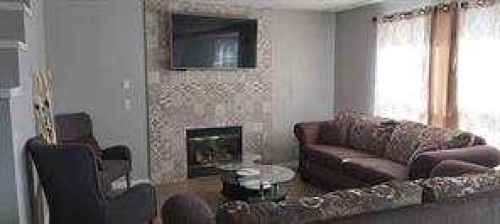 422 Bridlecreek Green Sw, Calgary, AB - Indoor Photo Showing Living Room With Fireplace
