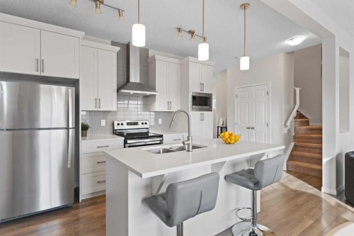 169 Buckskin Way, Cochrane, AB - Indoor Photo Showing Kitchen With Stainless Steel Kitchen With Double Sink With Upgraded Kitchen