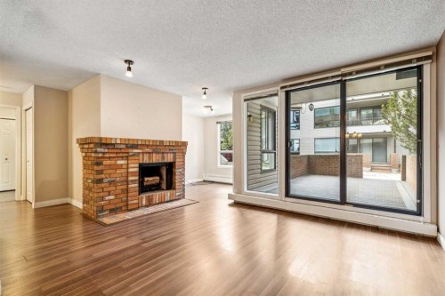105-2425 90 Avenue Sw, Calgary, AB - Indoor Photo Showing Living Room With Fireplace