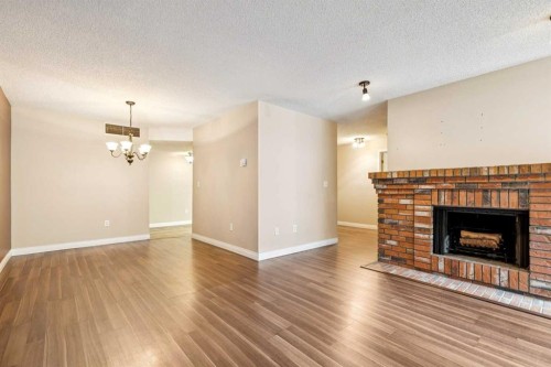 105-2425 90 Avenue Sw, Calgary, AB - Indoor Photo Showing Living Room With Fireplace