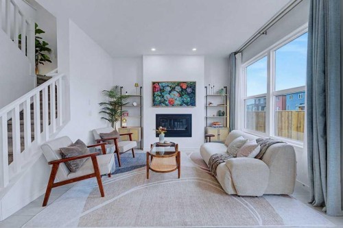 250 Hotchkiss Common Se, Calgary, AB - Indoor Photo Showing Living Room With Fireplace
