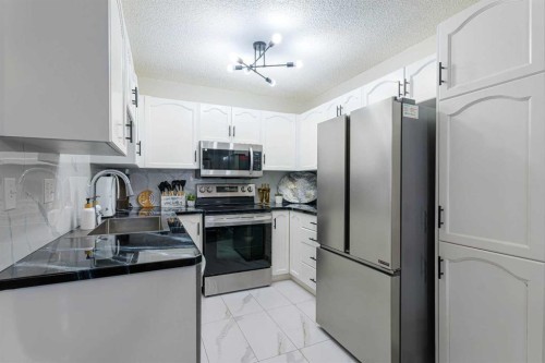 13 Mt. Aberdeen Manor Se, Calgary, AB - Indoor Photo Showing Kitchen With Stainless Steel Kitchen