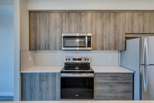 408-660 Shawnee Square Sw, Calgary, AB - Indoor Photo Showing Kitchen With Stainless Steel Kitchen
