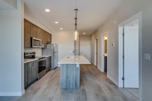 408-660 Shawnee Square Sw, Calgary, AB - Indoor Photo Showing Kitchen With Stainless Steel Kitchen