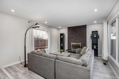 3394 Breton Close Nw, Calgary, AB - Indoor Photo Showing Living Room With Fireplace