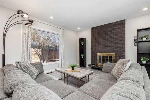 3394 Breton Close Nw, Calgary, AB - Indoor Photo Showing Living Room With Fireplace