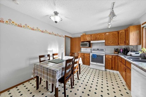 210 Shawinigan Way Sw, Calgary, AB - Indoor Photo Showing Kitchen With Double Sink