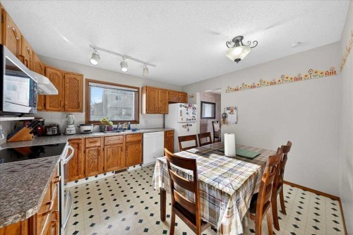 210 Shawinigan Way Sw, Calgary, AB - Indoor Photo Showing Kitchen With Double Sink