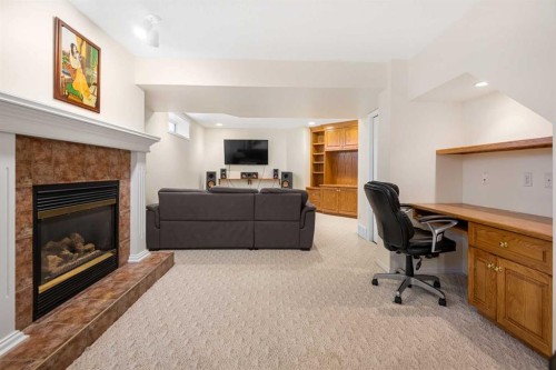 704 Woodside Drive, Airdrie, AB - Indoor Photo Showing Living Room With Fireplace