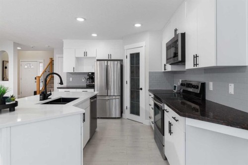 86 Cougarstone Court Sw, Calgary, AB - Indoor Photo Showing Kitchen With Double Sink With Upgraded Kitchen