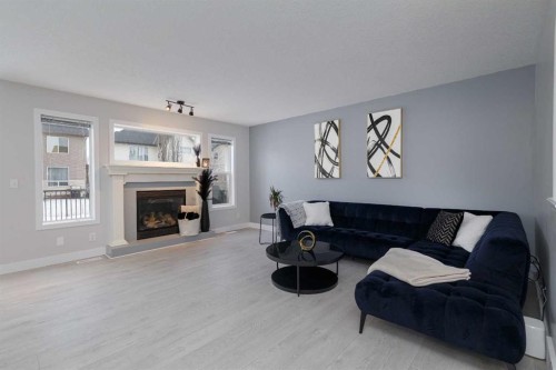 86 Cougarstone Court Sw, Calgary, AB - Indoor Photo Showing Living Room With Fireplace