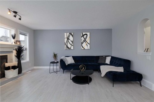 86 Cougarstone Court Sw, Calgary, AB - Indoor Photo Showing Living Room With Fireplace