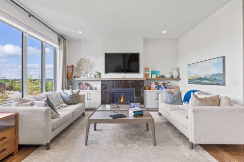 656 Bayview Way Sw, Airdrie, AB - Indoor Photo Showing Living Room With Fireplace