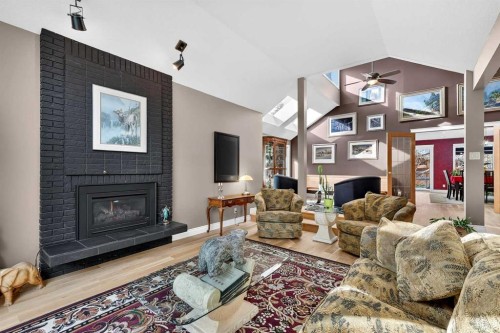 80 Oakmount Way Sw, Calgary, AB - Indoor Photo Showing Living Room With Fireplace