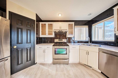 131 Arbour Wood Close Nw, Calgary, AB - Indoor Photo Showing Kitchen With Double Sink