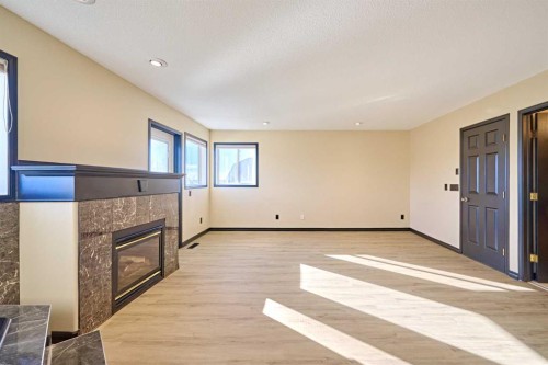 131 Arbour Wood Close Nw, Calgary, AB - Indoor Photo Showing Other Room With Fireplace
