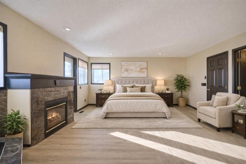 131 Arbour Wood Close Nw, Calgary, AB - Indoor Photo Showing Bedroom With Fireplace
