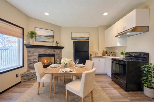 131 Arbour Wood Close Nw, Calgary, AB - Indoor Photo Showing Dining Room With Fireplace
