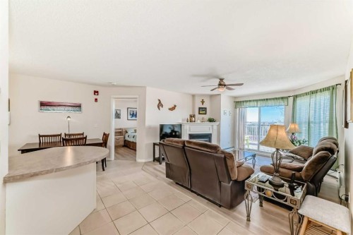 111-6900 Hunterview Drive Nw, Calgary, AB - Indoor Photo Showing Living Room With Fireplace
