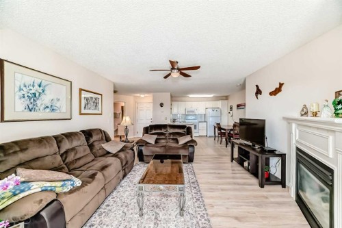 111-6900 Hunterview Drive Nw, Calgary, AB - Indoor Photo Showing Living Room With Fireplace