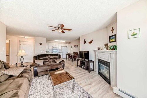 111-6900 Hunterview Drive Nw, Calgary, AB - Indoor Photo Showing Living Room With Fireplace