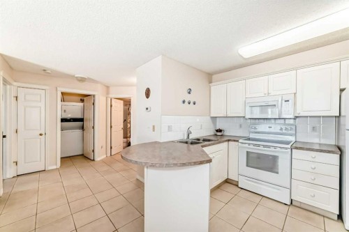 111-6900 Hunterview Drive Nw, Calgary, AB - Indoor Photo Showing Kitchen With Double Sink