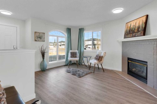 103 Canoe Square Sw, Airdrie, AB - Indoor Photo Showing Living Room With Fireplace