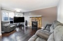 175-77 Glamis Green Sw, Calgary, AB  - Indoor Photo Showing Living Room With Fireplace 