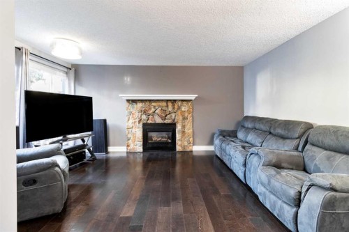 175-77 Glamis Green Sw, Calgary, AB - Indoor Photo Showing Living Room With Fireplace